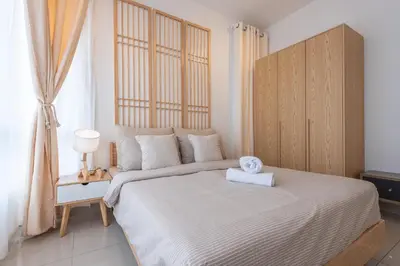 a bedroom with a large bed with a wooden headboard at Serene Muji Family Cottage(2-7pax) & Sunrise View in Cameron Highlands