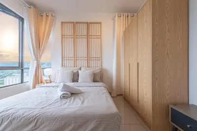 a bedroom with a large bed with a large window at Serene Muji Family Cottage(2-7pax) & Sunrise View in Cameron Highlands