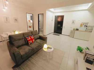 a living room with a brown couch and a table at Infinity Pool, Georgetown, Up to 11 Pax, 2 Bedrooms, 2 Bathrooms, 2 Car Parks by Star Home in Jelutong