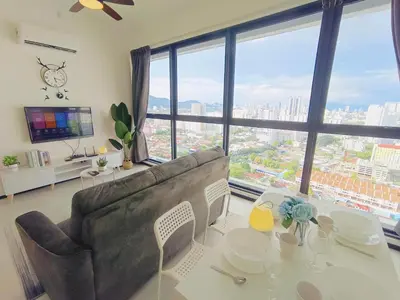 a living room with a couch and a table at Infinity Pool, Georgetown, Up to 11 Pax, 2 Bedrooms, 2 Bathrooms, 2 Car Parks by Star Home in Jelutong
