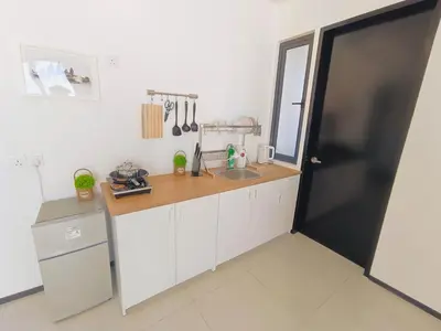 a kitchen with white cabinets and a wooden counter top at Infinity Pool, Georgetown, Up to 11 Pax, 2 Bedrooms, 2 Bathrooms, 2 Car Parks by Star Home in Jelutong