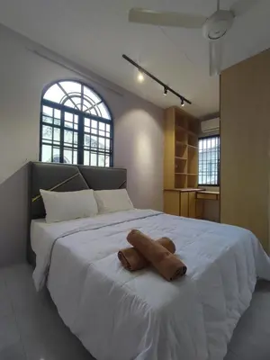 a large white bed with a stuffed animal on it at Ipoh Tambun Sunway 5 Rooms Spacious Homestay in Tambun