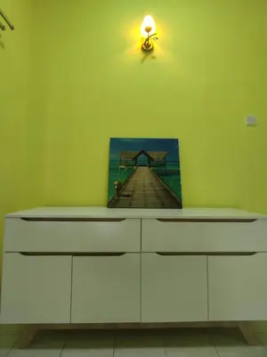 a white dresser with a painting of a pier at Ipoh Tambun Sunway 5 Rooms Spacious Homestay in Tambun