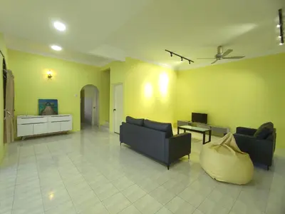 a living room with two couches and a table at Ipoh Tambun Sunway 5 Rooms Spacious Homestay in Tambun