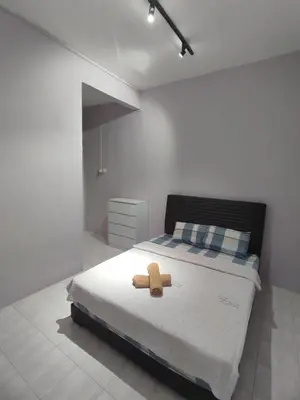 a teddy bear sitting on a bed in a bedroom at Ipoh Tambun Sunway 5 Rooms Spacious Homestay in Tambun