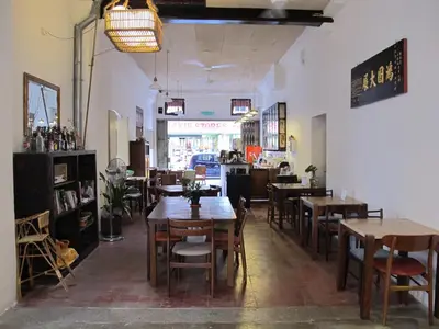 a restaurant with tables and chairs in a room at Ren I Tang Heritage Inn in George Town