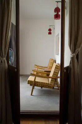 two lounge chairs sitting in a room through a door at Ren I Tang Heritage Inn in George Town