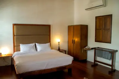 a bedroom with a large white bed and a cabinet at Ren I Tang Heritage Inn in George Town