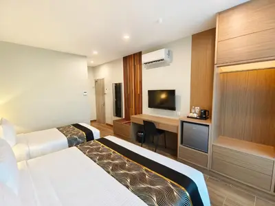 a hotel room with two beds and a television at ZOOM HOTEL in George Town