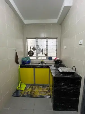a kitchen with a sink and a yellow counter at CRYSTAL D CAMERON HOMESTAY in Cameron Highlands