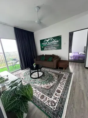 a living room with a couch and a rug at CRYSTAL D CAMERON HOMESTAY in Cameron Highlands