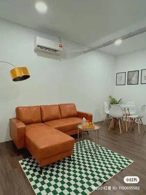 a living room with a brown couch and a table at Penang Heritage Home in George Town