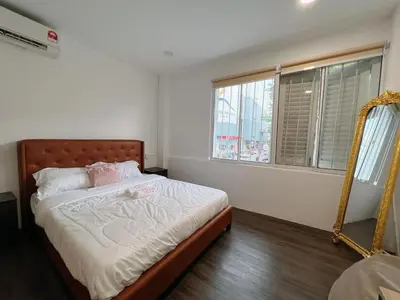 a bedroom with a bed with a mirror and windows at Penang Heritage Home in George Town