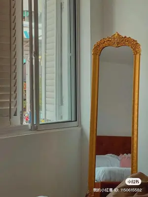 a mirror in a room next to a window at Penang Heritage Home in George Town