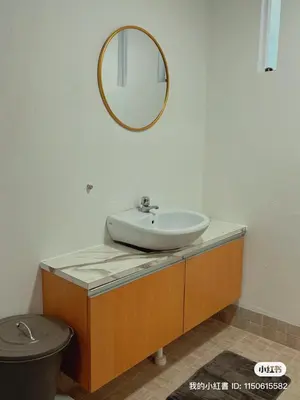 a bathroom with a sink and a mirror and a toilet at Penang Heritage Home in George Town