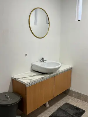 a bathroom with a sink and a mirror at Penang Heritage Home in George Town