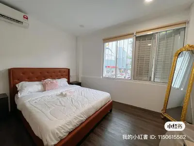 a bedroom with a bed and two windows at Penang Heritage Home in George Town