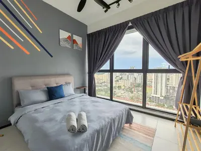 a bedroom with a bed with two towels on it at Modern Elegance Suite, 5 to 6 pax at Urban Suites Georgetown by SuperStay in Jelutong
