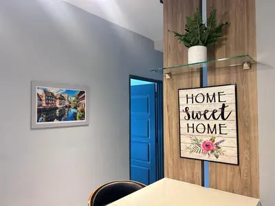 a table with a sign that reads home sweet home at Seaview Mansion One 2R2B George Town Gleneagles Gurney Komtar by Cozy Cottage Haven in George Town