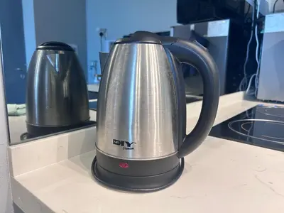 a silver and black tea kettle on a kitchen counter at Seaview Mansion One 2R2B George Town Gleneagles Gurney Komtar by Cozy Cottage Haven in George Town