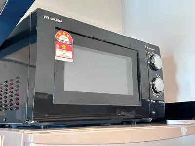 a microwave oven sitting on top of a table at Seaview Mansion One 2R2B George Town Gleneagles Gurney Komtar by Cozy Cottage Haven in George Town