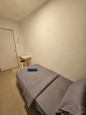 a hospital room with a bed and a table at SS HOSTEL PENANG in George Town