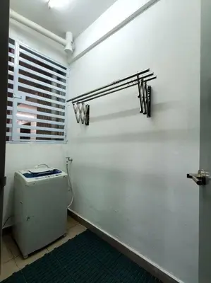 a white bathroom with a toilet and a window at Adinda Homestay @ RPB Hospital, Ipoh in Ipoh