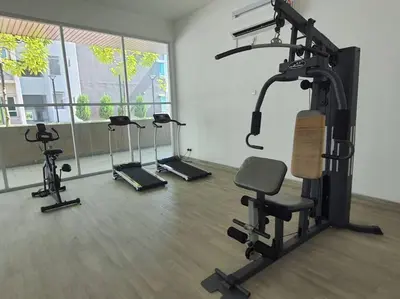 a gym with several tread machines in a room at Adinda Homestay @ RPB Hospital, Ipoh in Ipoh