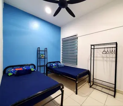 a bedroom with two beds and a ceiling fan at Adinda Homestay @ RPB Hospital, Ipoh in Ipoh