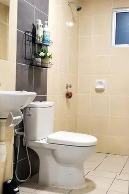a bathroom with a white toilet and a sink at Adinda Homestay @ RPB Hospital, Ipoh in Ipoh