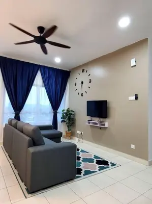 a living room with a couch and a clock on the wall at Adinda Homestay @ RPB Hospital, Ipoh in Ipoh