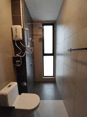 a bathroom with a toilet and a window at Seaview Infinity Pool #6pax #2bedroom #2bathroom in Jelutong