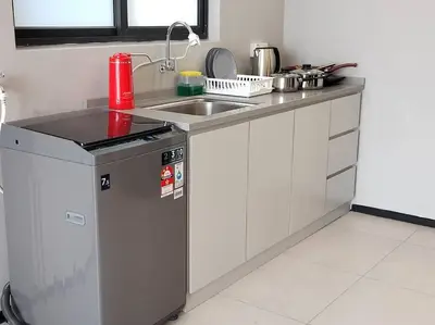 a kitchen with a sink and a counter top at Seaview Infinity Pool #6pax #2bedroom #2bathroom in Jelutong