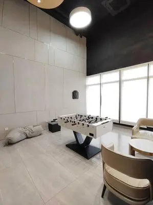 a room with a ping pong table and chairs at Seaview Infinity Pool #6pax #2bedroom #2bathroom in Jelutong