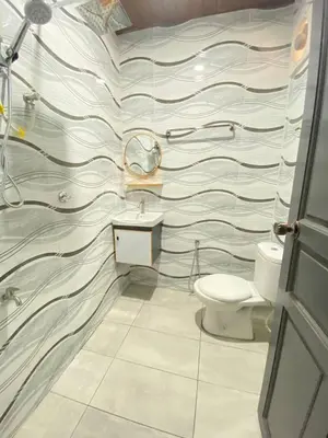 a bathroom with a sink and a toilet at Nahdhoh Hotel in Kubang Semang