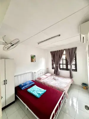 a bedroom with a red bed in a room at Sarah homestay Muslim Permatang Pauh in Permatang Pauh