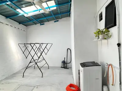 a room with a television and a chair in it at Sarah homestay Muslim Permatang Pauh in Permatang Pauh