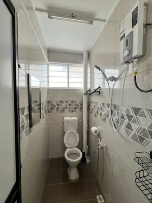a bathroom with a toilet and a shower stall at Sarah homestay Muslim Permatang Pauh in Permatang Pauh