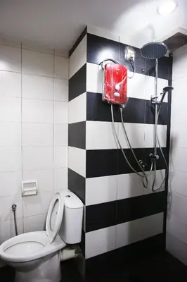 a bathroom with a black and white checkered wall at Private GameRoom and Cinema at The CEO Penang in Bayan Lepas
