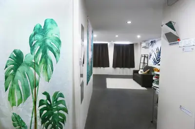 a hallway with a living room with plants on the wall at Private GameRoom and Cinema at The CEO Penang in Bayan Lepas