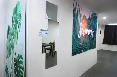 a hallway with a table and a poster on a wall at Private GameRoom and Cinema at The CEO Penang in Bayan Lepas