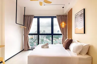a bedroom with a bed and a large window at Urban Suites, Signature Collection by Stellar ALV in Jelutong