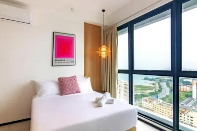 a bedroom with a white bed and a large window at Urban Suites, Signature Collection by Stellar ALV in Jelutong