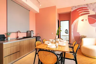 a kitchen and dining room with a table and chairs at Urban Suites, Signature Collection by Stellar ALV in Jelutong