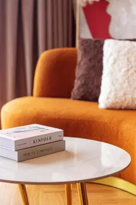 two books on a coffee table next to a couch at Urban Suites, Signature Collection by Stellar ALV in Jelutong