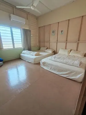 a room with two beds and a large window at Grandpa House \u7237\u7237\u8001\u5bb6 in Gopeng