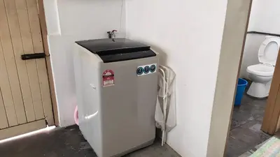 a trash can in a bathroom with a toilet at Grandpa House \u7237\u7237\u8001\u5bb6 in Gopeng