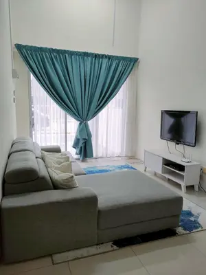 a living room with a couch and a large window at Rana Homestay Ipoh Perak in Tanjung Rambutan