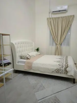 a bedroom with a white bed and a window at Rana Homestay Ipoh Perak in Tanjung Rambutan