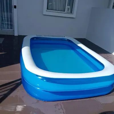 a blue and white tub sitting next to a building at Rana Homestay Ipoh Perak in Tanjung Rambutan